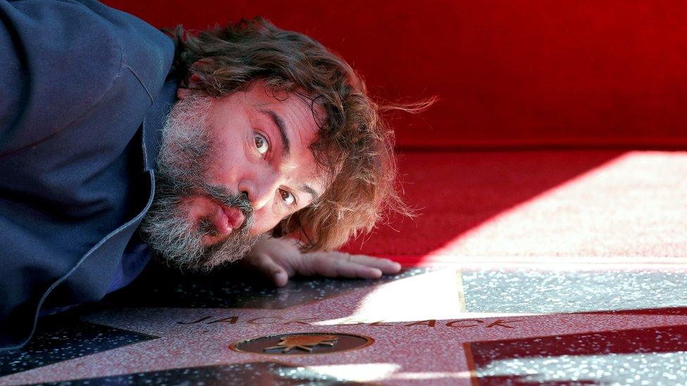 Jack Black poses with his star.