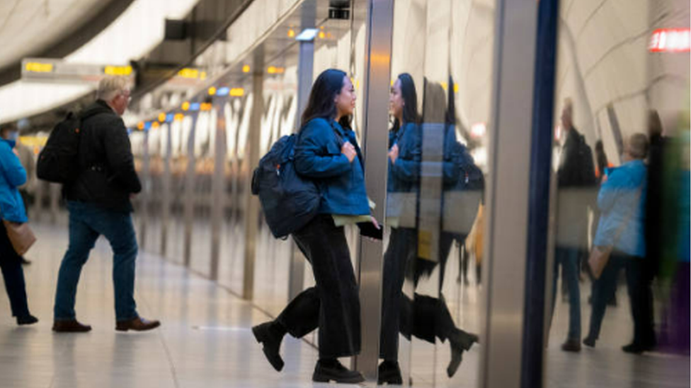 Passengers walking on a London Underground platform