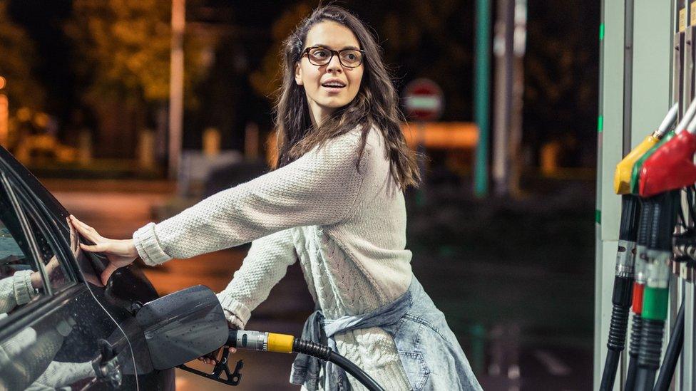 Woman filling up car with petrol