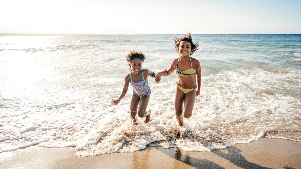 girls-running-on-a-beach