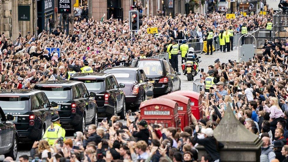 Thousands of people line the streets of Edinburgh as the procession passes