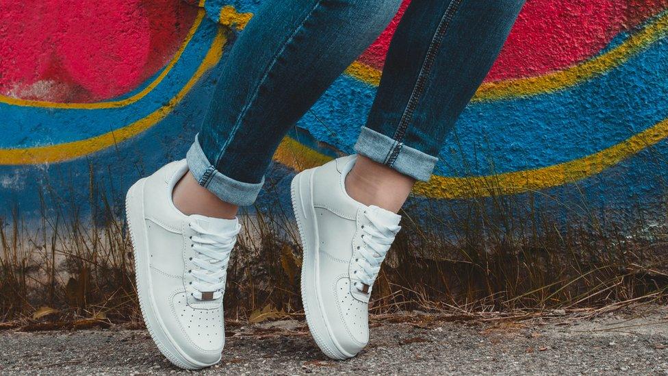 Woman in white trainers