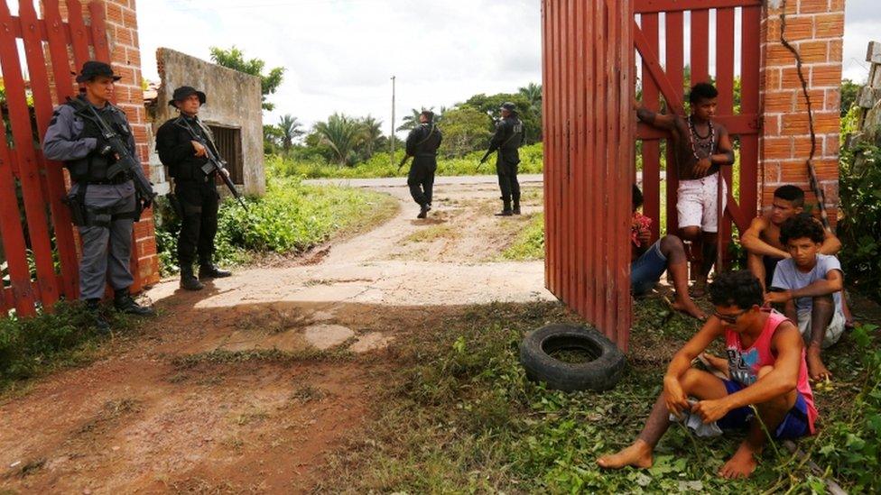 Members of Brazil's indigenous Gamela tribe are pictured near police after members of their tribe were injured in a dispute over land in northern Brazil, 3 May 2017