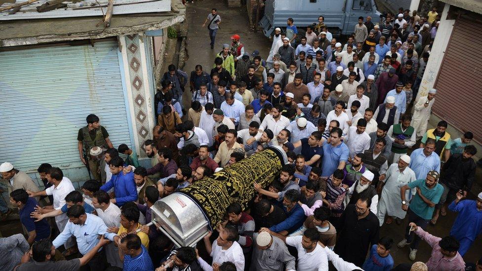 Kashmiri Muslims carry the coffin of Shujaat Bukhari during a funeral procession