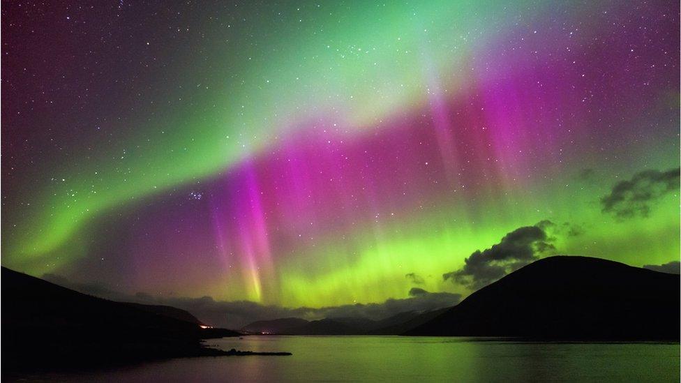 An Aurora Borealis can be seen over the Scottish highlands