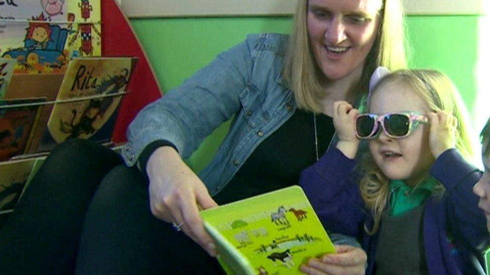 Natalie and daughter reading book