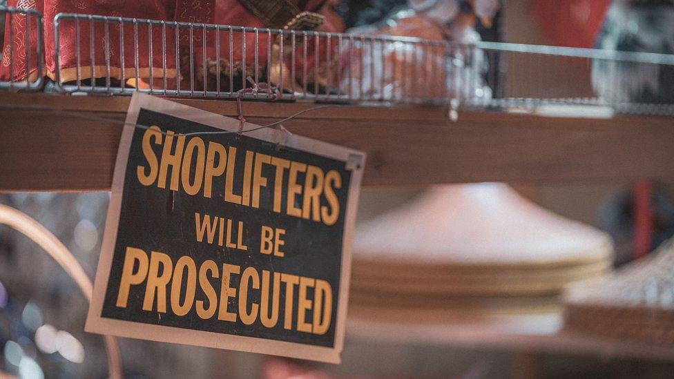 Sign reading 'shoplifters will be prosecuted'