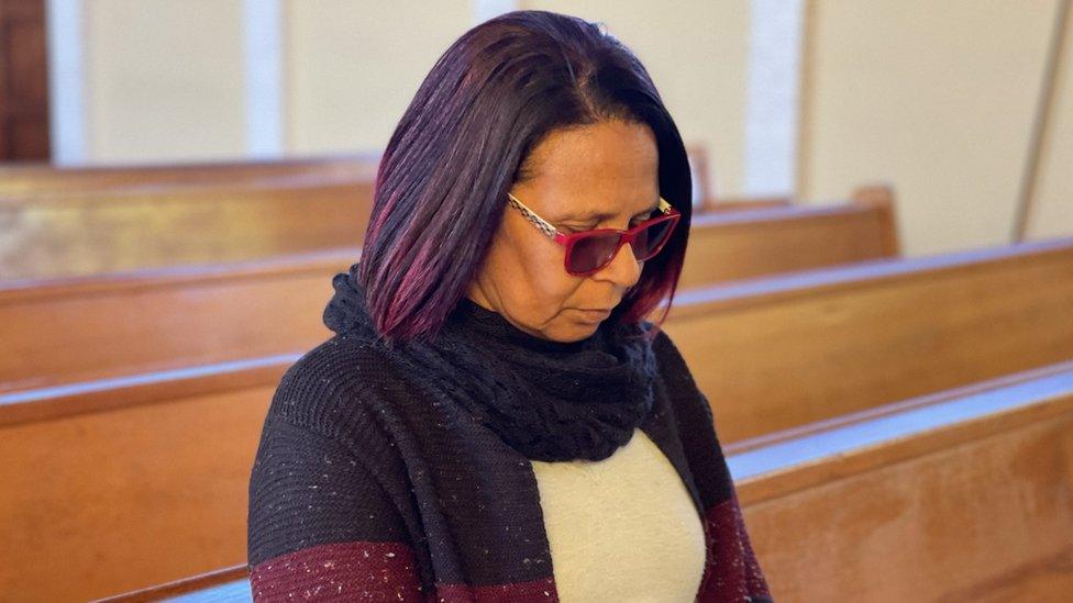 Lesley Wyngaard grieving her son Rory in a church