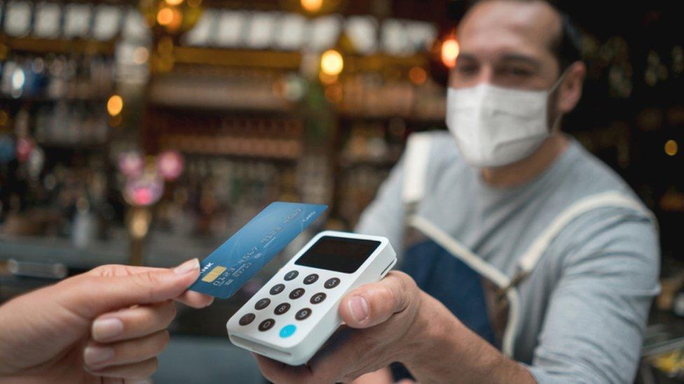 man offering chip and pin payment