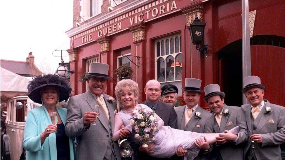 Dame Barbara Windsor (Peggy Mitchell) and Mike Reid (Frank Butcher second left), with co-stars (left-right) Pam St Clement (Pat Evans), Ross Kemp (Grant Mitchell), Steve McFadden (Phil Mitchell), Shaun Williamson (Barry Evans), and Tony Caunter (Roy Evans)