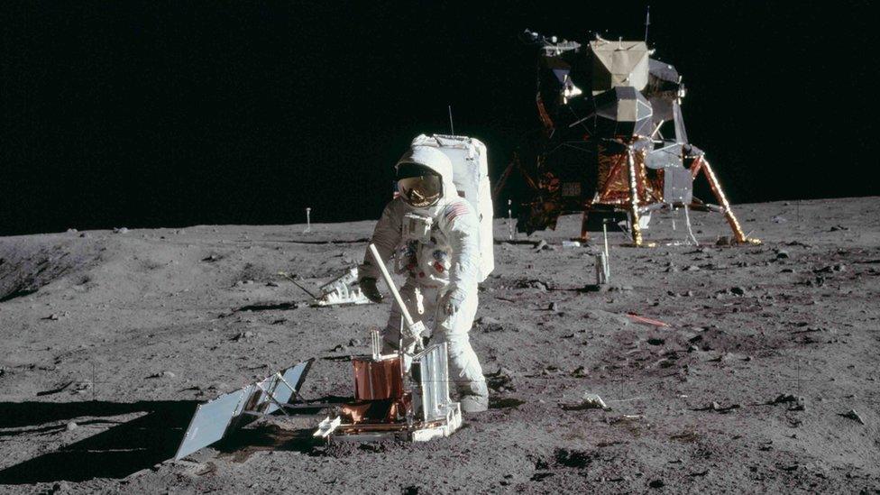 Buzz Aldrin deploys a scientific research package on the surface of the moon on July 20 1969