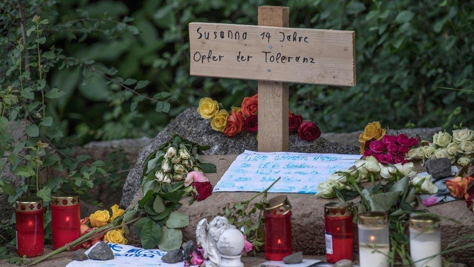 A cross with the words 'Susanna, 14, victim of tolerance' at a makeshift memorial