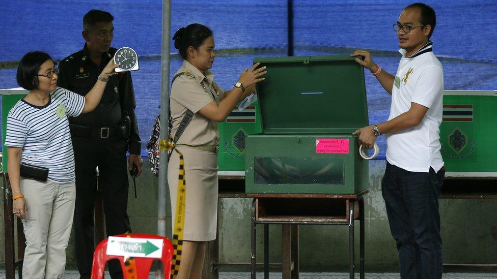 Officials over see ballot boxes during Thailand's referendum