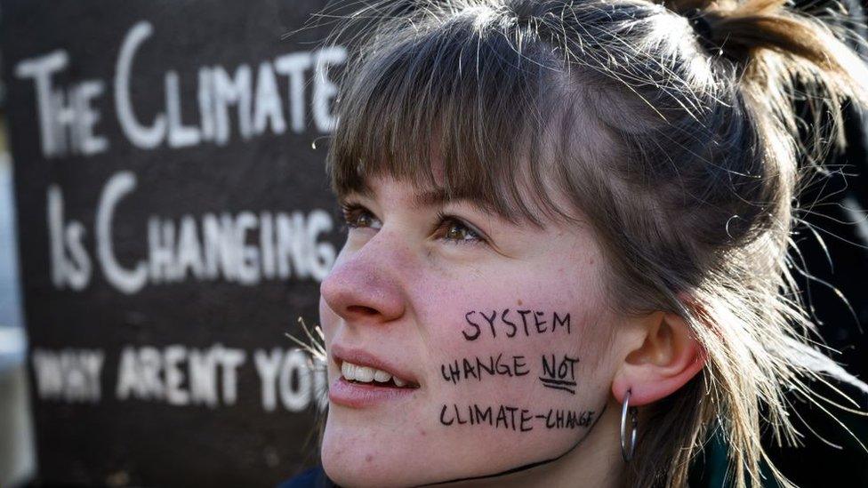 Woman with slogan painted on her face