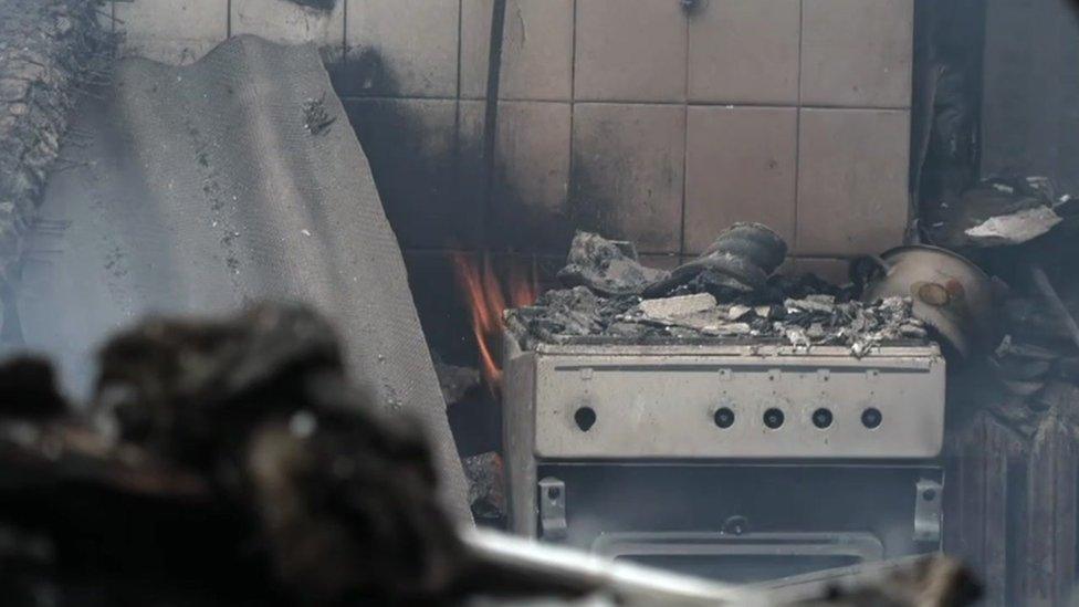 A smouldering kitchen in a destroyed house north-west of Kyiv