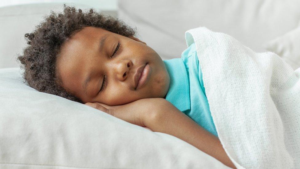 Boy asleep on pillow