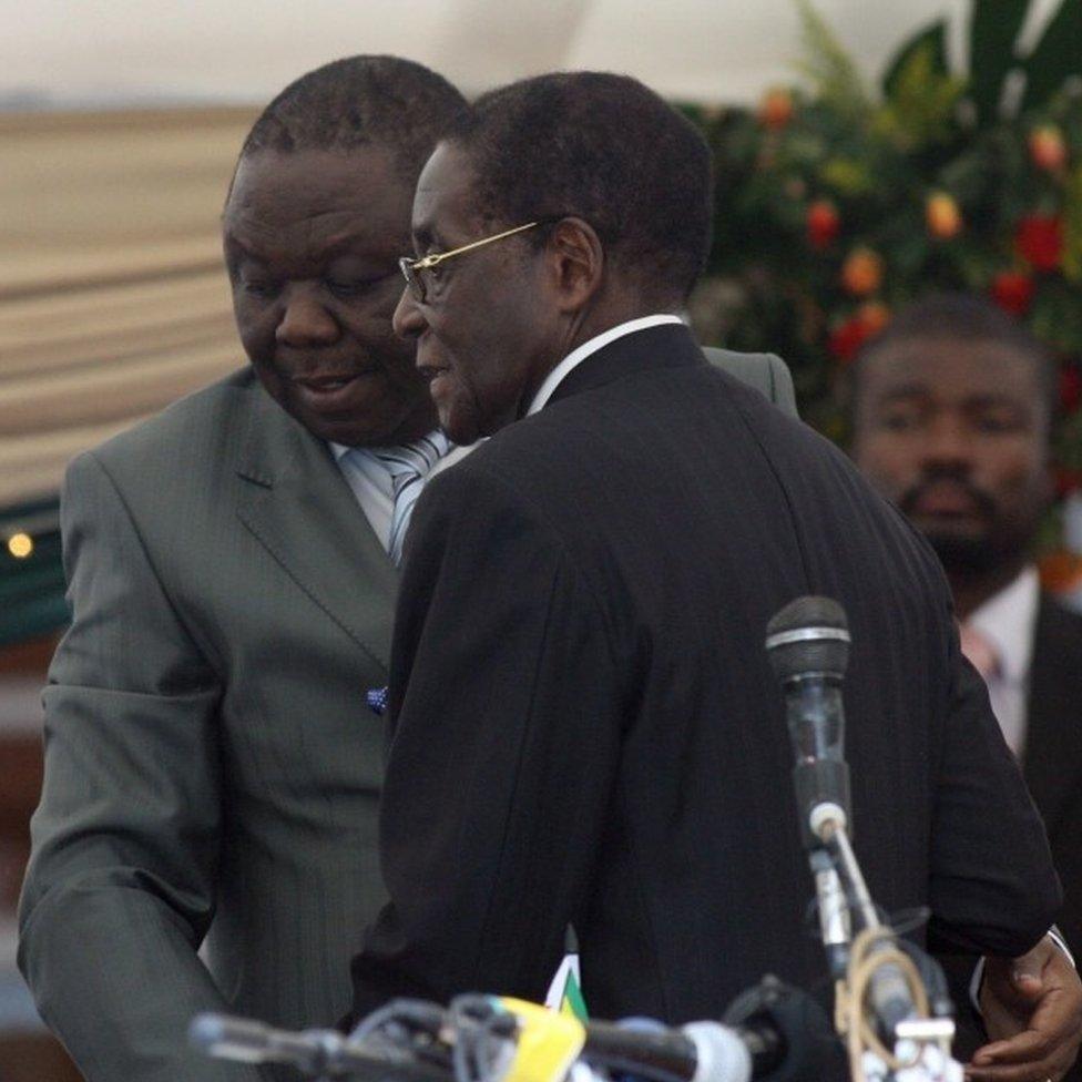 Morgan Tsvangirai leaves after being sworn in by President Robert Mugabe