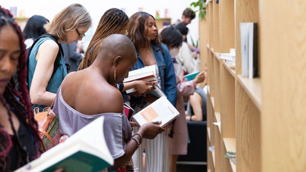 People holding books at the festival