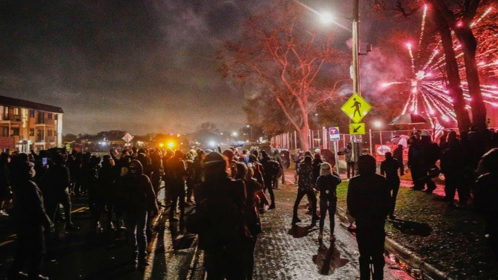 Protesters throw fireworks towards police outside Brooklyn Center Police Department a day after Daunte Wright was shot and killed by a police officer, April 12, 2021