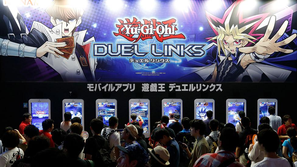 Visitors play Yu-Gi-Oh! Duel Links video game in the Konami Holdings Corp. booth at Tokyo Game Show on September 17, 2016