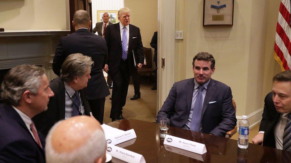 President Donald Trump walks into the Roosevelt Room for a meeting with Mark Sutton of International Paper, Jeff Fettig of Whirlpool, White House Senior Counselor Steve Bannon, Kevin Plank of Under Armour, Elon Musk of SpaceX (L) and other other business leaders at the White House on 23 January 2017 in Washington, DC.