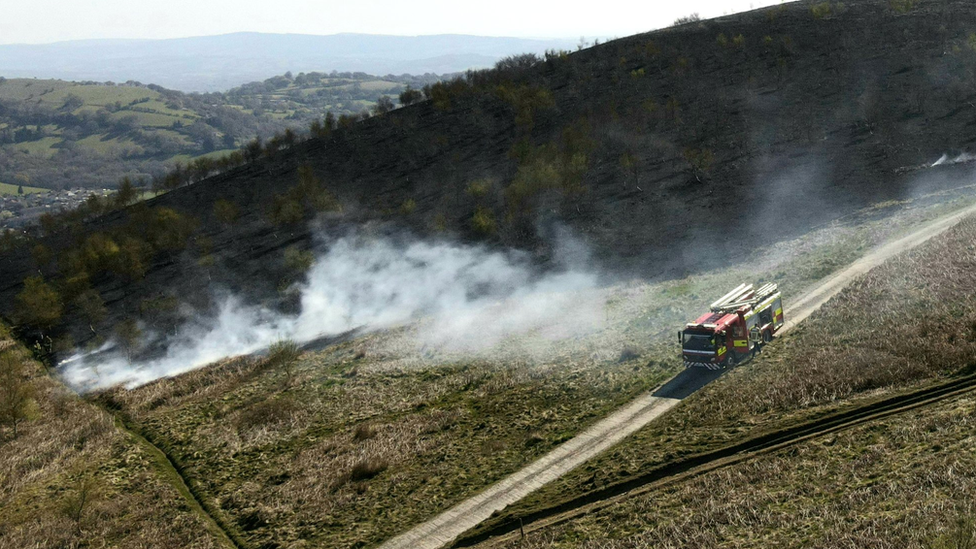 A fire engine is seen at Machen mountain at the scene of a grass fire