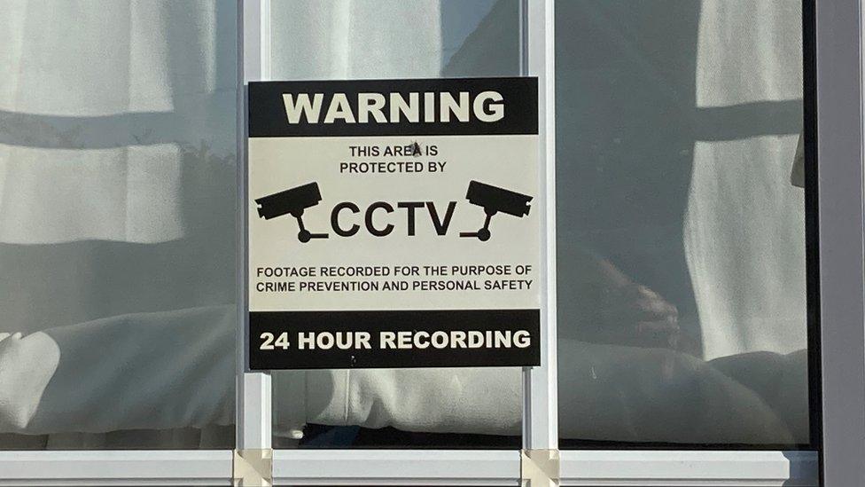 A CCTV sign in a window