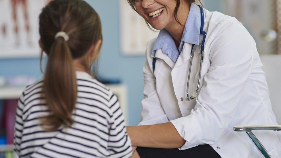 Girl speaks to doctor