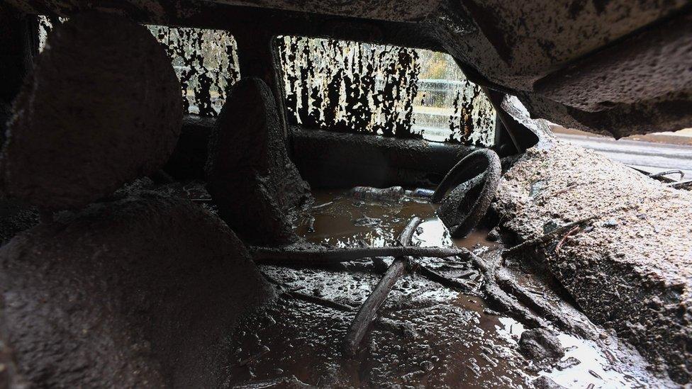 Mud fills the interior of a car destroyed in a rain-driven mudslide in a neighbourhood under mandatory evacuation in Burbank, California.