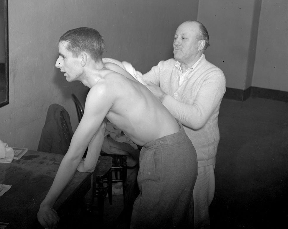 Table tennis player Eric Filby having a rub down after a playing an Irish contestant in a competition at the Royal Albert Hall, London. (Photo by London Express/Getty Images)