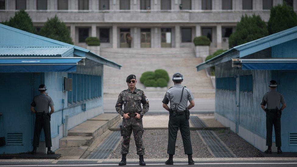 South Korean soldiers stand guard at the border village of Panmunjom in the Demilitarized Zone (DMZ) between South and North Korea on February 7, 2018 in Panmunjom