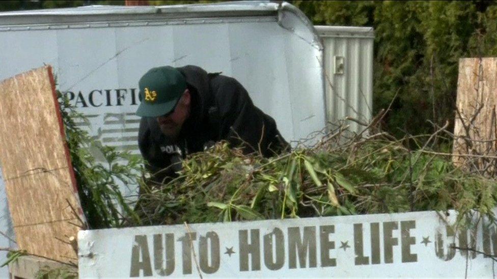 A police officer searches the scene of the crime in Kent, near Seattle.