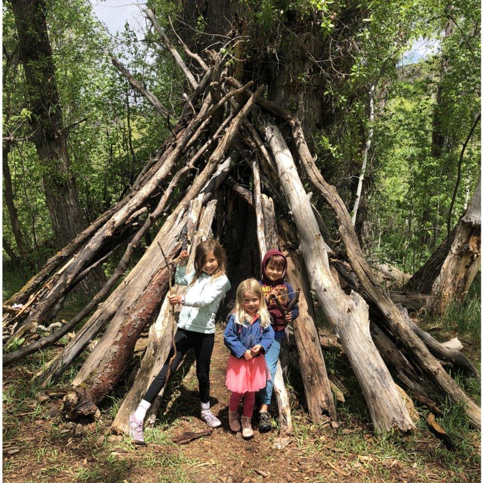 Alyssa Hulme's children building fairy houses.