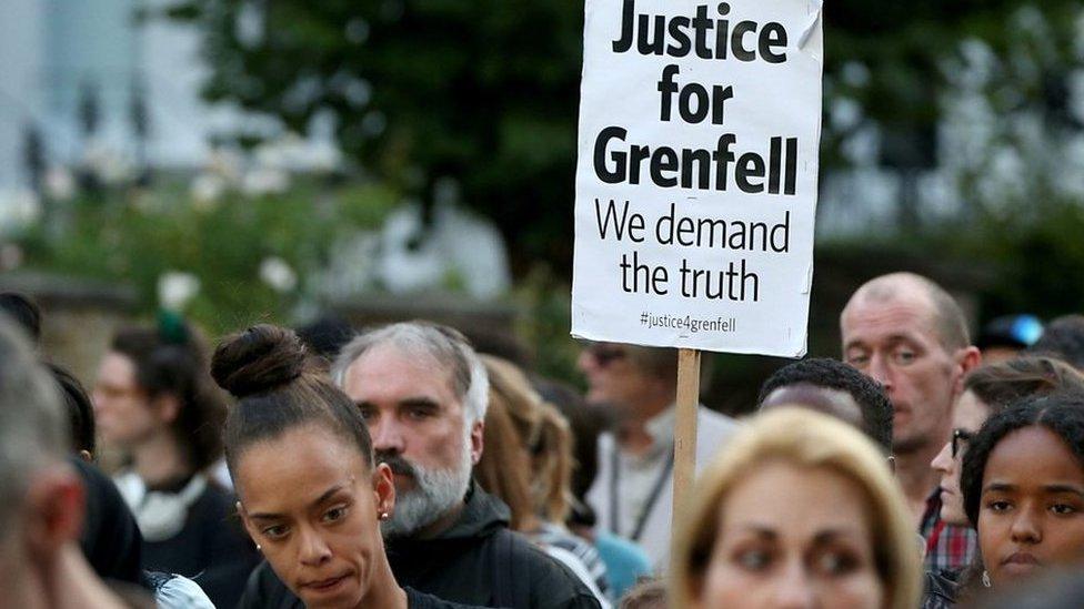 Grenfell campaigners with poster