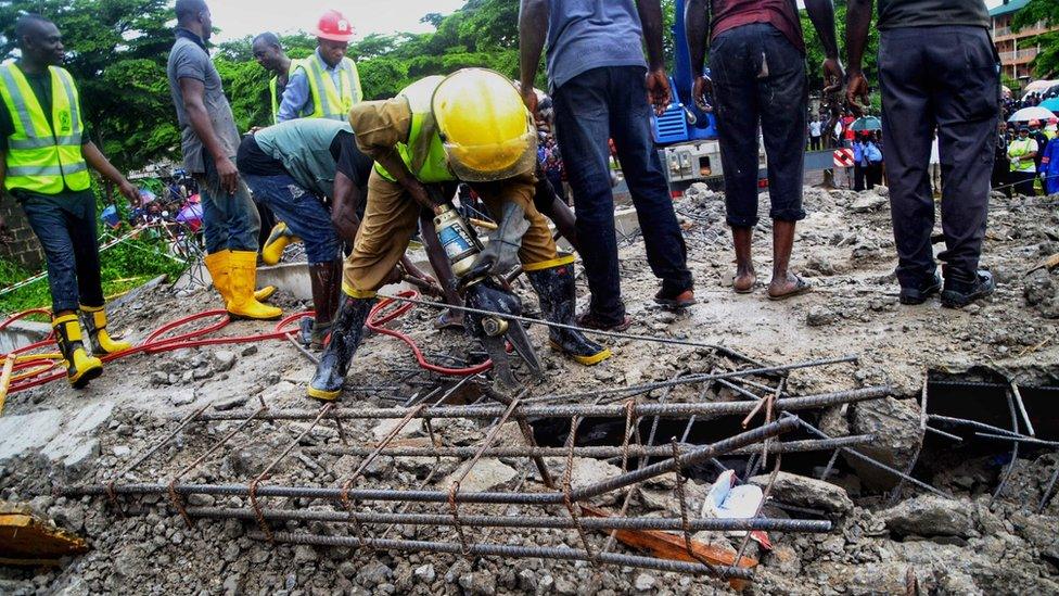 Rescue workers at the scene of a collapsed mall in Abuja, Nigeria - August 2018