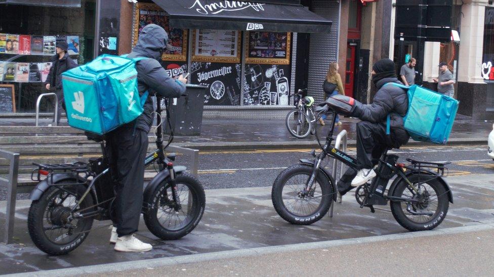 Two Deliveroo couriers