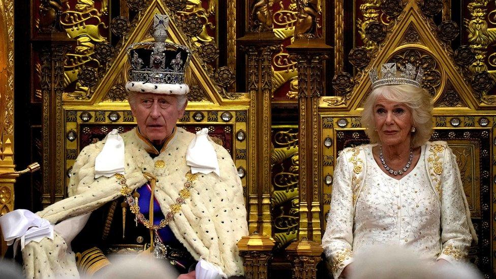 King Charles III sits beside Queen Camilla as he reads the King's Speech