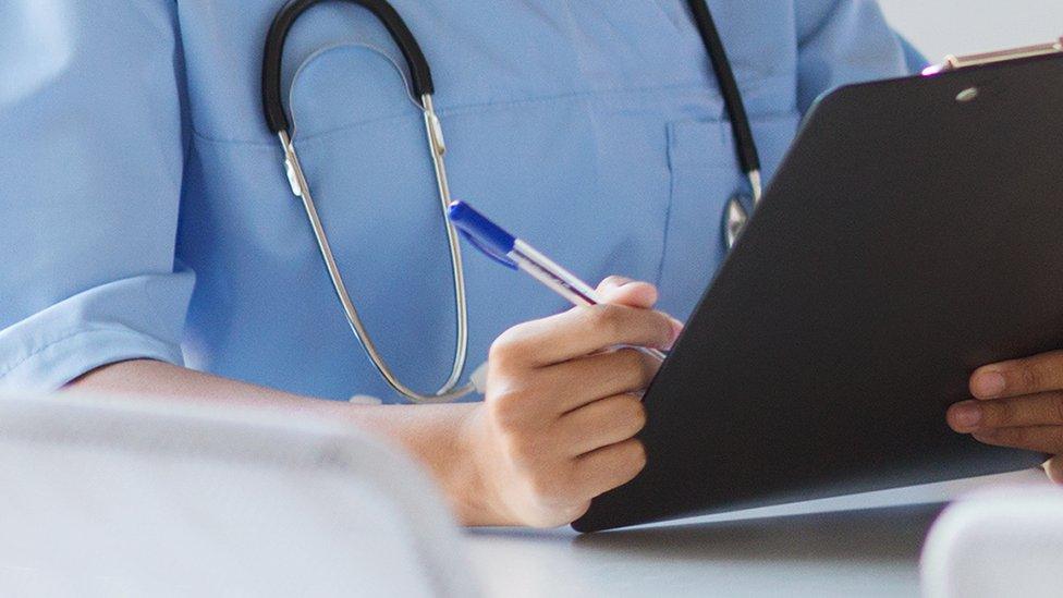 A nurse holding a clipboard