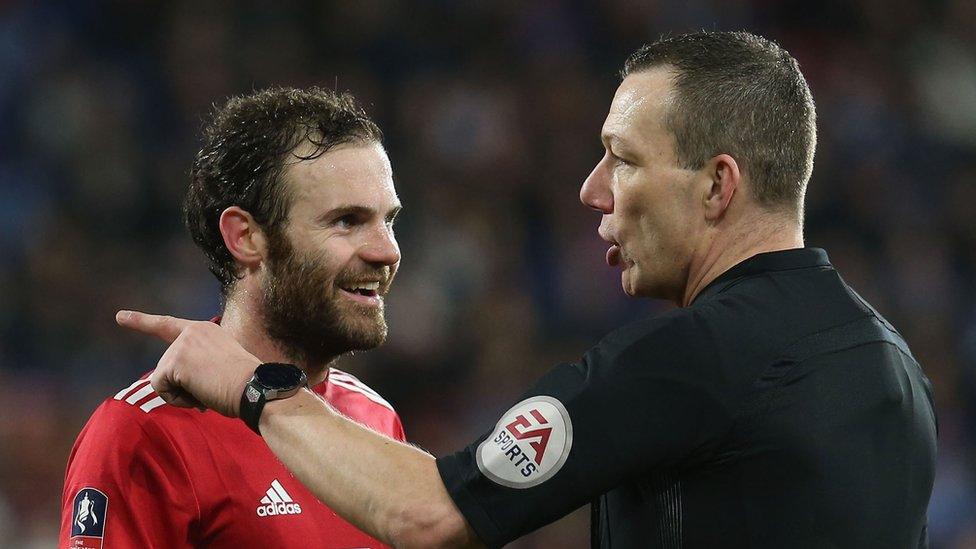 Juan Mata and referee Kevin Friend