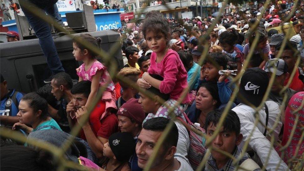 Members of the migrant caravan push forward at a gate separating Guatemala from Mexico on 19 October 2018 in Ciudad Tecun Uman, Guatemala.