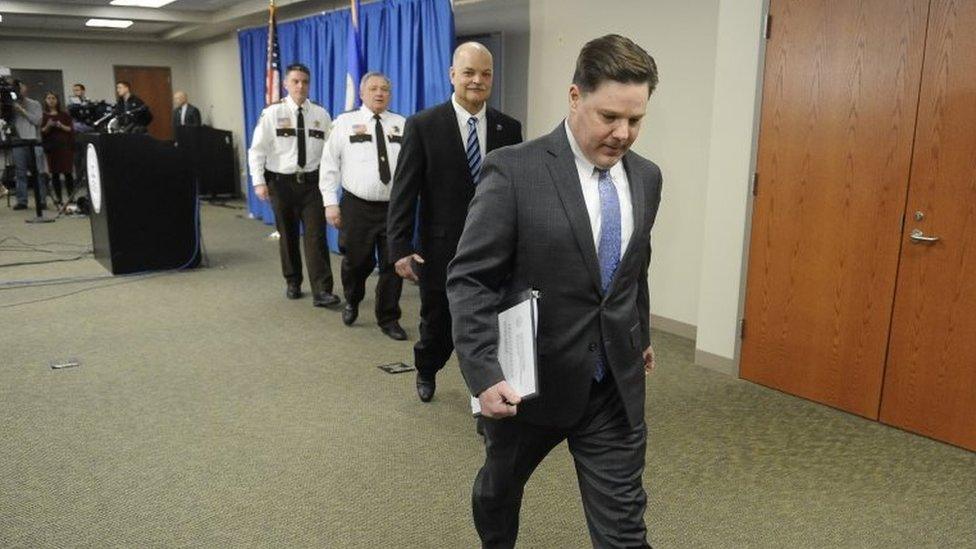 Carver County Attorney Mark Metz (R) leaves the news conference in Chaska, Minnesota, on 19 April 2018