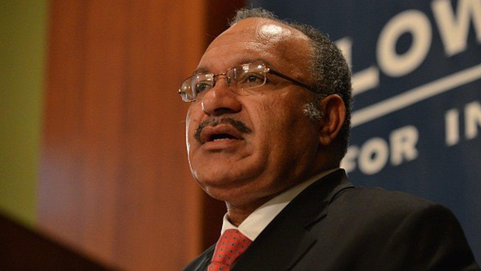 Papua New Guinea Prime Minister Peter O'Neill speaking at a podium