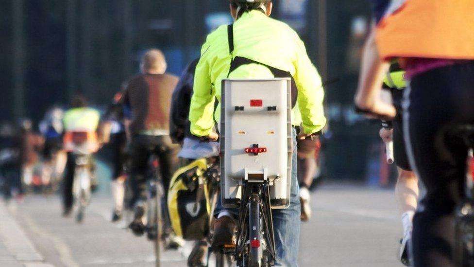 Cycling commuters on a busy road