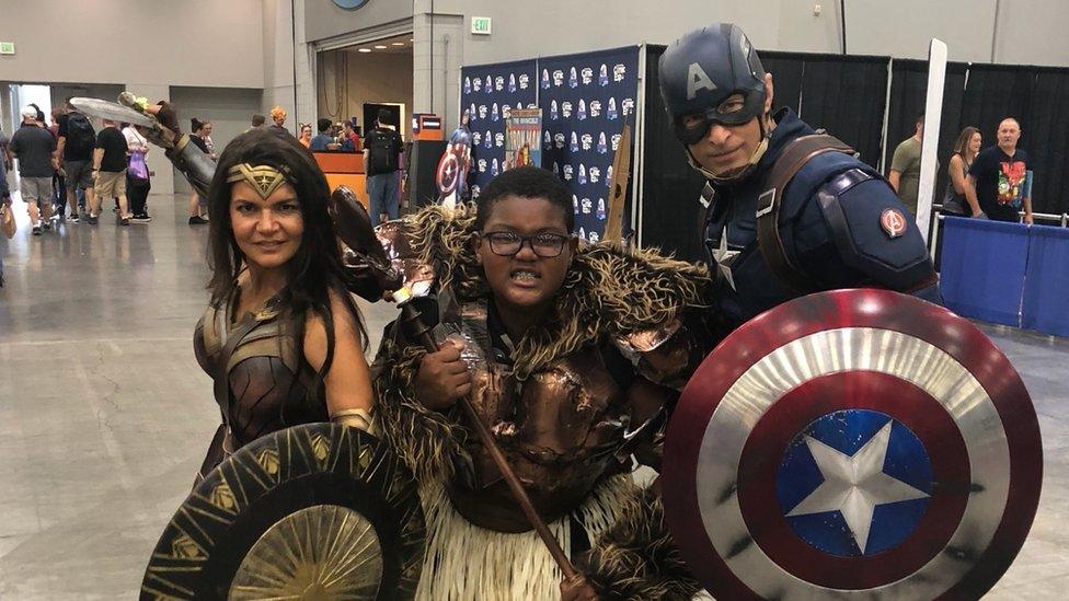 Stephanie Hardy's son posing with his favourite superheroes at a Comic Expo