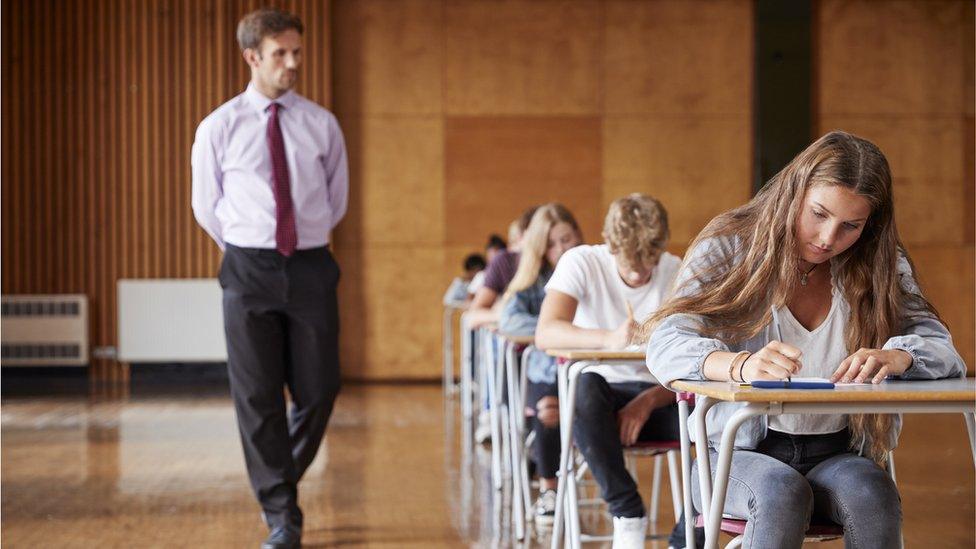 Invigilator watching exam progress