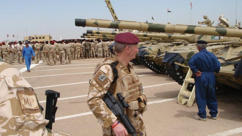 General Moore standing in front of tanks in Baghdad