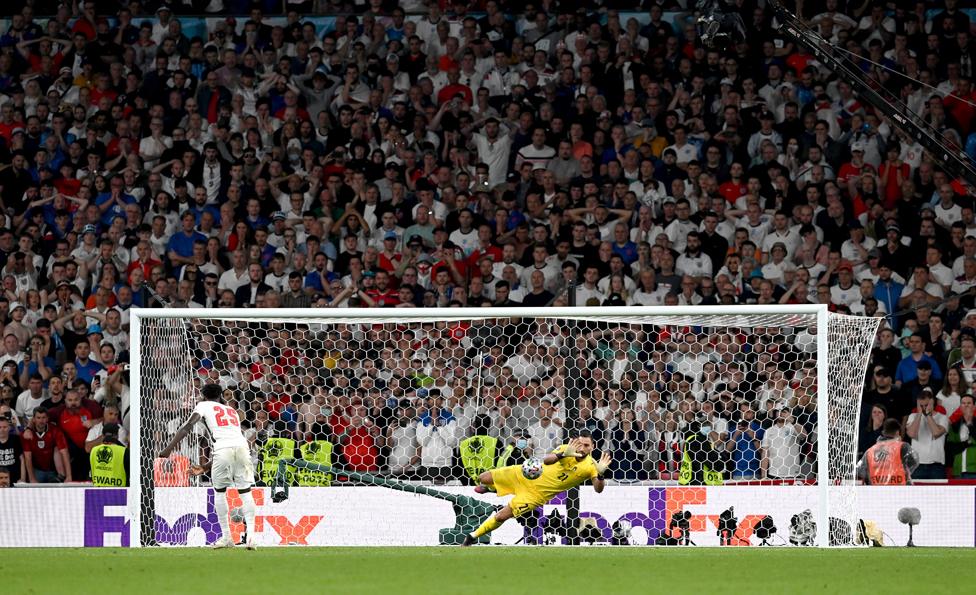 Bukayo Saka of England misses his team's fifth penalty in a penalty shoot out which is saved by Gianluigi Donnarumma of Italy during the penalty shoot out in the UEFA Euro 2020 Championship Final between Italy and England at Wembley Stadium on July 11, 2021 in London, England.