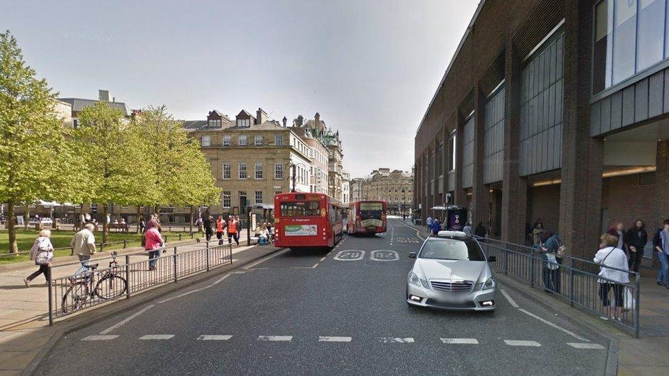 Street view of the street showing buses and cars on road