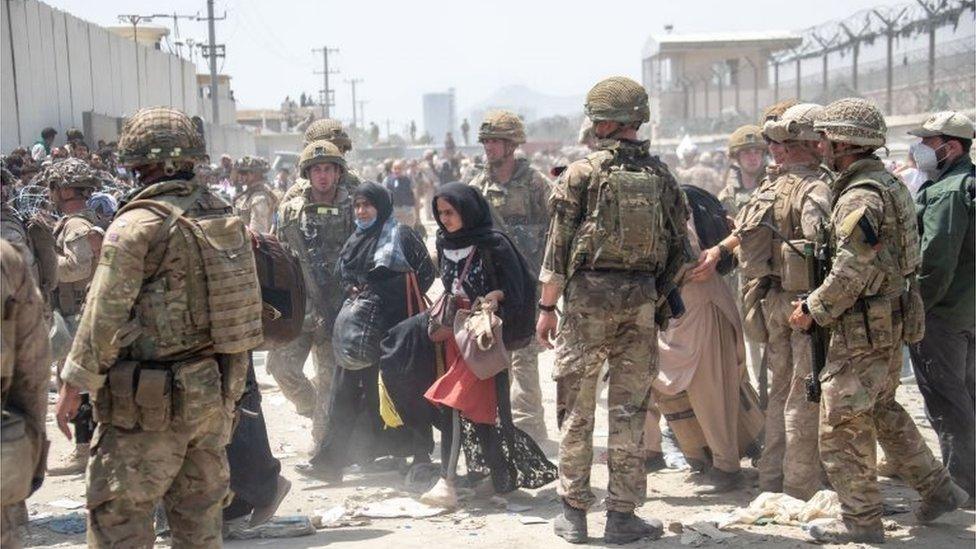 Members of the British and US military engaged in the evacuation of people out of Kabul, Afghanistan