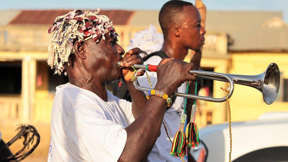 A man blows a trumpet during the Aboakyer festival, in Winneba, Ghana.